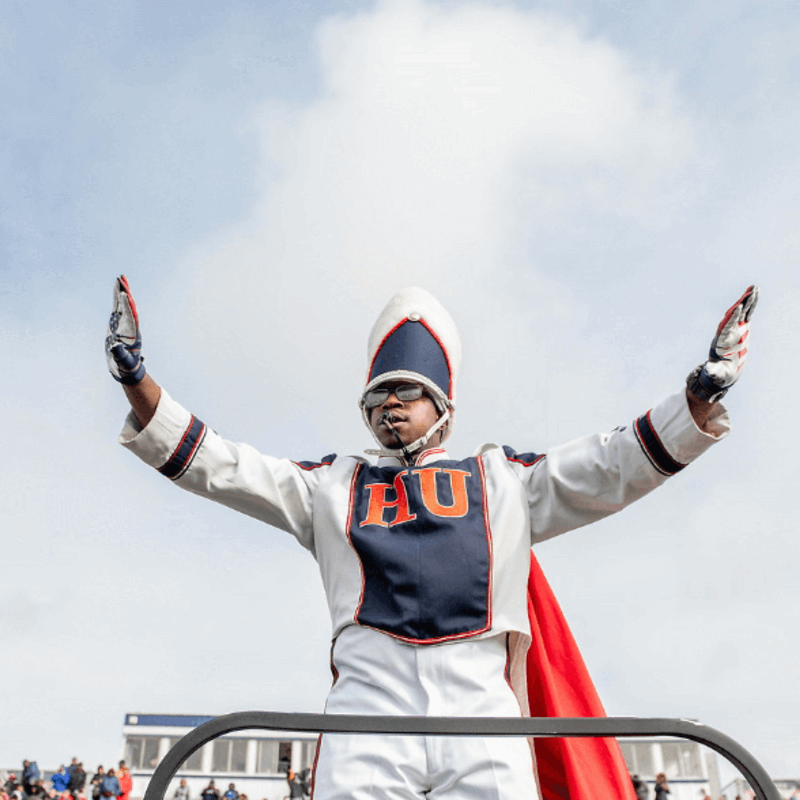 A member of the Howard University marching band performing at Greene Stadium for a Homecoming event.