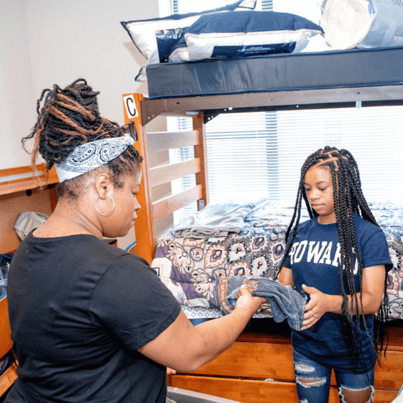 A student and a family member setting up a dorm room on Move-In Day.