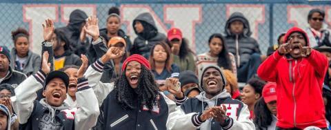 Howard students and alumni cheering at a university event.