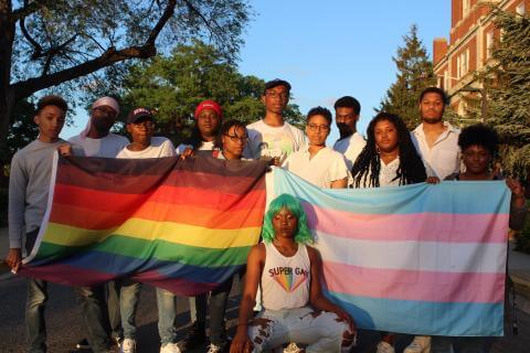 young black students holding LGBTQ flags