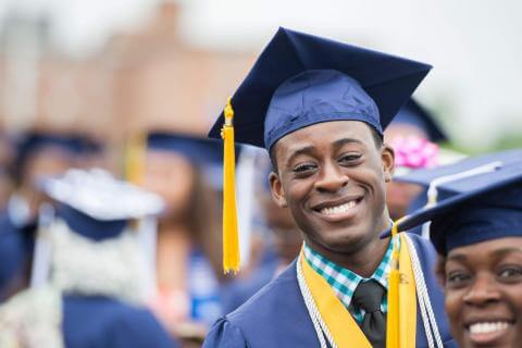 A young man in Howard graduation regalia.