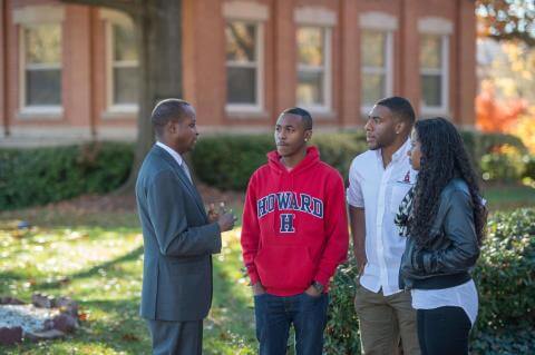 Howard University President Wayne A. I. Frederick talks to students on campus.