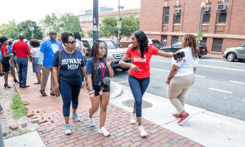 A Howard student and her mother being led on a tour around campus.