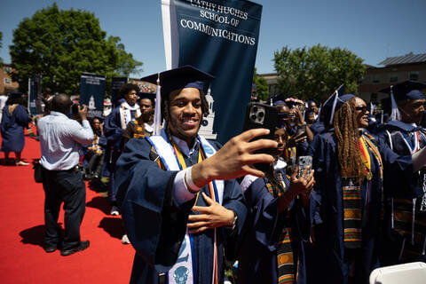 Student at graduation taking a selfie